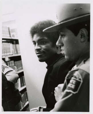 Photo of a student getting arrested during Black student protest in Wilbur Cross Library, April 1974. University of Connecticut Archives.