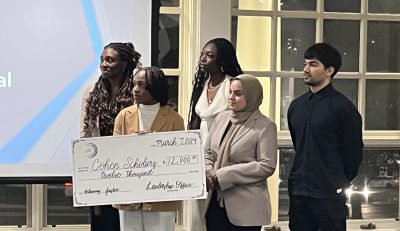 Cohen Scholarship recipients holding $12,000 check